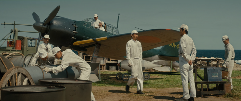 File:Godzilla Minus One - Tachibana and the mechanics inspecting Shikishima's Zero.png