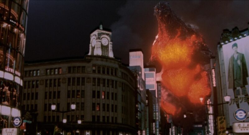 File:GvD - Godzilla walks past the Wako Main Building.jpg
